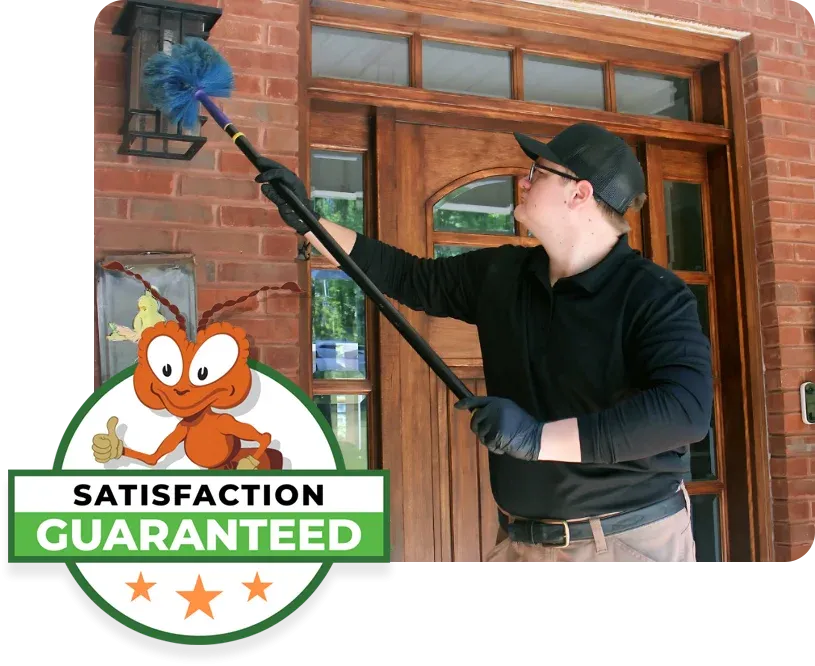 technician cleaning exterior of house